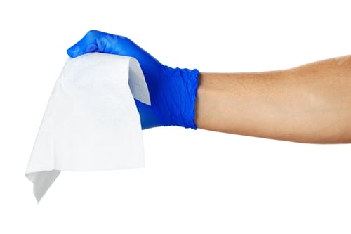 Preview: Hand with blue gloves takes a white cloth