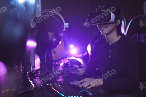 Man Wearing VR Headset Using Game Controller