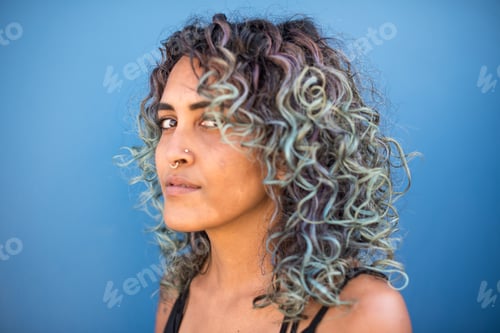 Preview: Woman with colorful hair shot against blue background