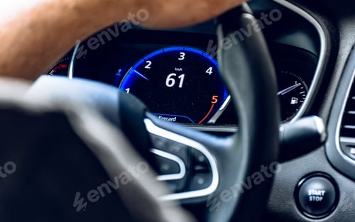Preview: Close-up of hand holding steering wheel while driving a car.