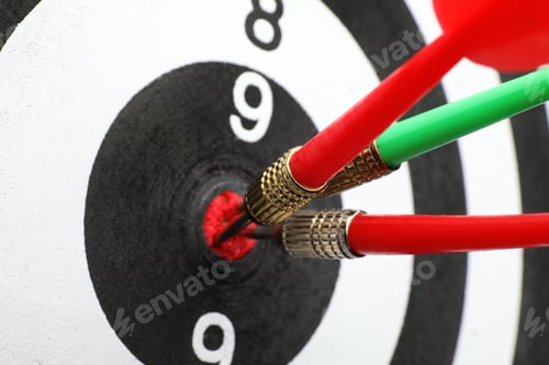 Preview: Dart board with color arrows hitting target, closeup