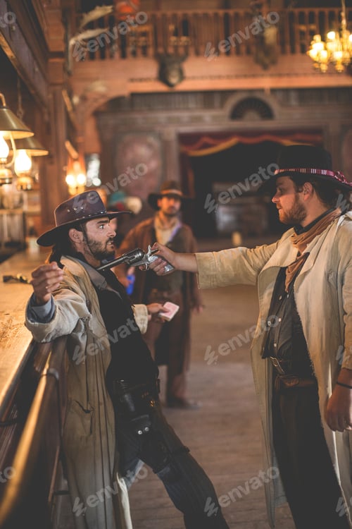 Preview: Cowboy aining handgun in saloon on wild west film set, Fort Bravo, Tabernas, Almeria, Spain