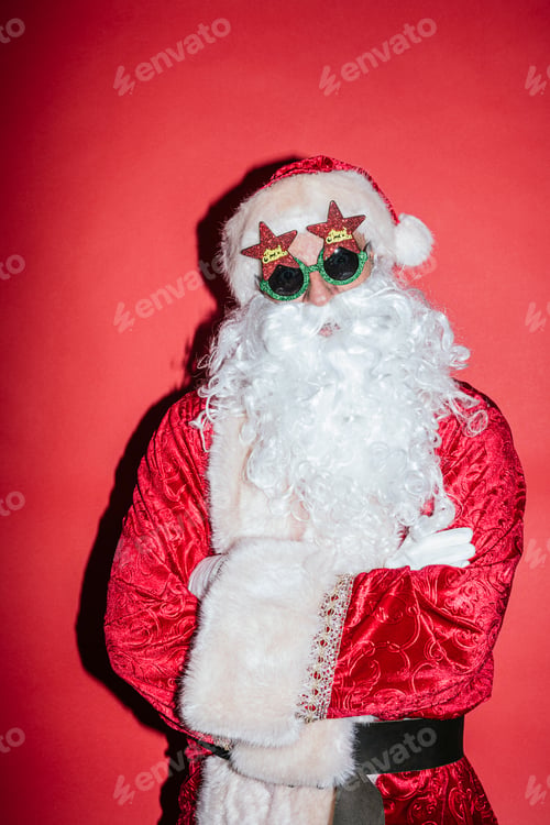 Preview: Man dressed as Santa Claus gesturing with funny glasses