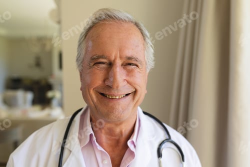 Preview: Portrait of senior caucasian male doctor looking at camera and smiling
