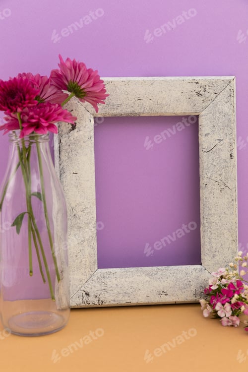 Preview: Rustic wooden frame with vase of flowers on purple and orange background