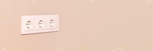 Preview: Electrical outlets on beige wall banner