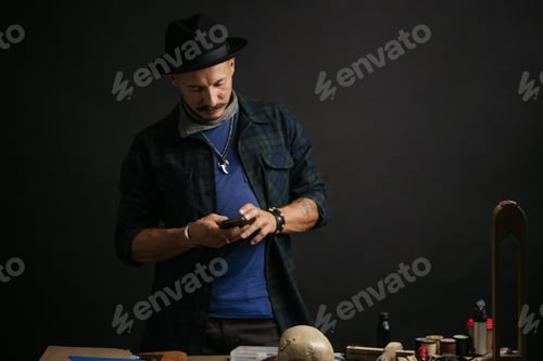 Preview: Professional shoemaker in his workshop making and repairing custom made shoes