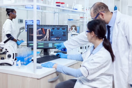 Preview: Group of scientist working with computer in laboratory