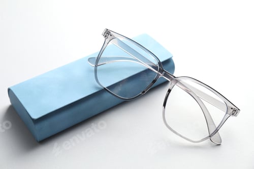 Preview: Case with stylish glasses on light background, closeup
