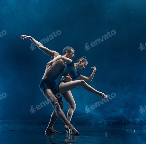 Preview: Young couple of ballet dancers dancing unde rwater drops