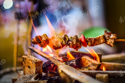 Preview: Closeup shot of a skewer with meat on a burning fire
