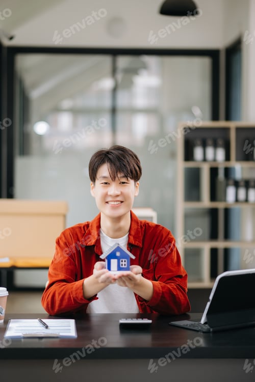 Preview: Young real estate agent worker working with laptop and tablet at table in office