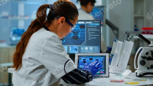 Preview: Scientist using digital tablet working in modern medical research laboratory