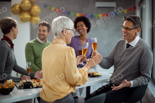 Preview: Happy entrepreneurs toasting with Champagne on a party in the office.