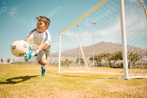 Vista previa: Football, boy goalkeeper and jump, saving ball from goals at outdoor sports field. Soccer, kid and