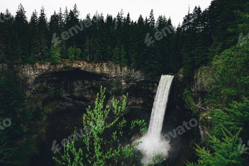 Preview: Aerial shot of Brandywine Falls Provincial Park with evergreen trees around a waterfall