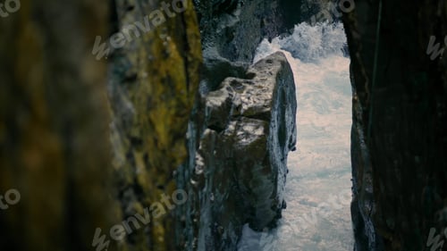 Preview: Foamy sea streaming at rocks nature closeup. Frothy water breaking at cliffside