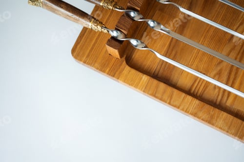 Preview: beautiful skewers on wood barbecue. background with copy space