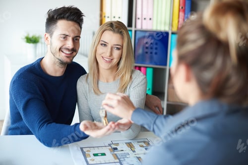 Preview: Estate agent giving keys to couple