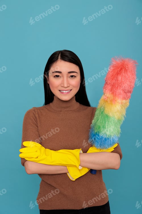 Preview: Glad smiling and optimistic asian houseworker cross hands from chores