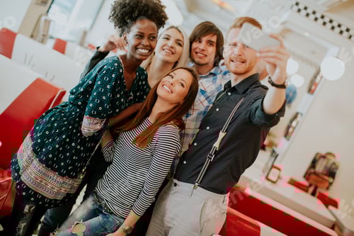 Preview: Group of young people taking selfie with mobile phone