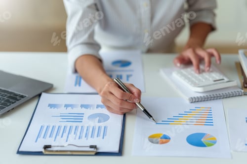 Preview: Business woman analyzing charts and graphs for comparison each quarter, showing a change in market