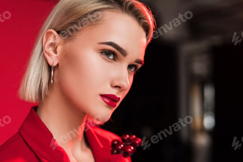 Preview: portrait of attractive stylish girl in red jacket with boutonniere