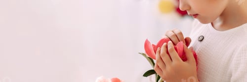 Preview: Girl 6-7 years old in a white dress holds a flower
