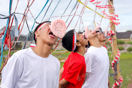 Preview: Young Indonesian Men With Headbands Intensely Participate In Traditional Cracker Eating Race