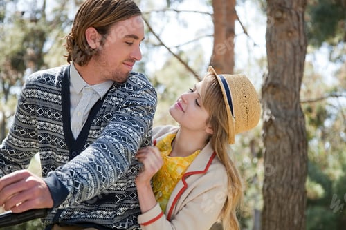 Preview: A couple sharing a tender moment in the park on a sunny day