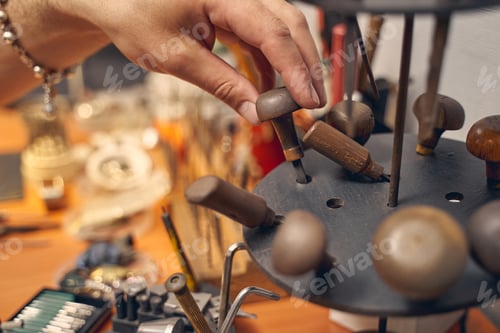 Preview: Caucasian male hand touching a jewelry instrument