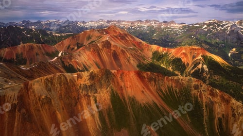 Preview: a scenic view from an air plane above mountains covered in a rainbow colored