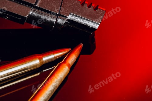 Preview: Black gun and cartridges on background with red reflection