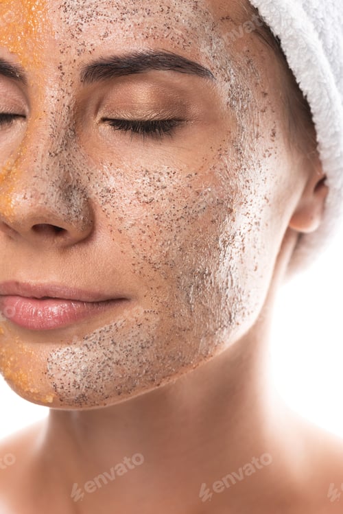 Preview: partial view of young woman with scrub on face with closed eyes isolated on white