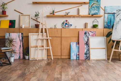 Preview: spacious light painting studio with wooden cabinets, shelves, easels and paintings