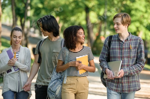 Preview: Young happy students walking while talking. Looking aside.