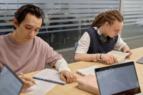 Preview: Gen Z Student Studying over Book at Seminar