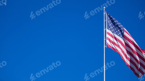 Preview: American Flag Waving Against Bright Blue Sky