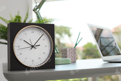 Preview: Analog clock on table in office. Time to work