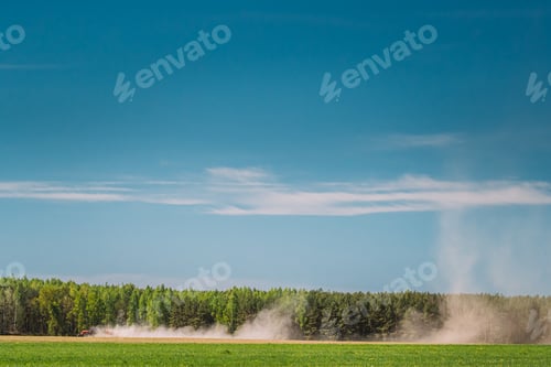 Preview: Tractor With Seed Drill Machine Sowing The Seeds For Crops In Spring Season. Beginning Of