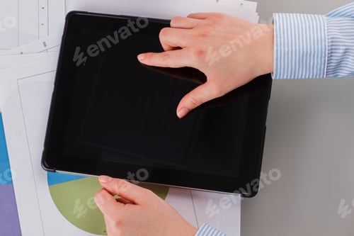 Preview: Business woman working with tablet at workplace.