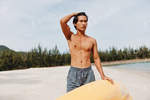 Preview: Kayak Beach Adventure: A Happy Asian Man Exercising in the Summer Sun, Paddling his Oar on a