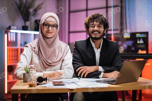 Preview: Confident two multi ethnic economists, young experienced muslim female and businessman