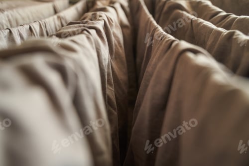 Preview: Close up of brown fabric folds creating abstract pattern with soft lighting