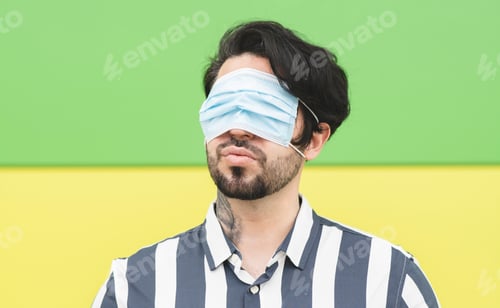 Preview: man covers his eyes with a medical mask