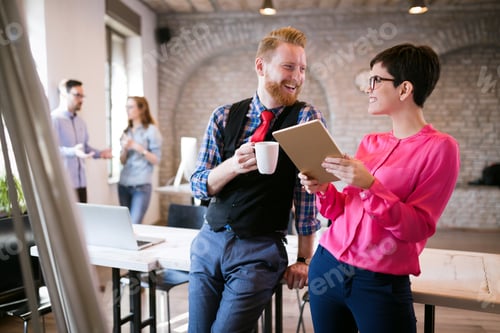 Preview: Young attractive architects discussing in modern office