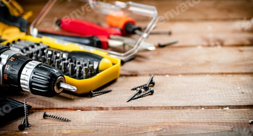 Preview: Cordless Drill and Screws on Wooden Surface