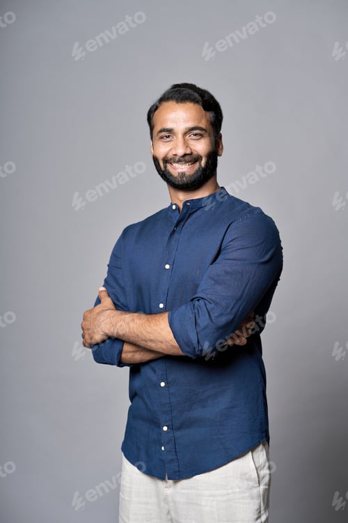 Preview: Smiling indian business man executive isolated on gray, vertical portrait.