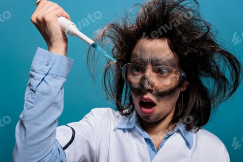 Preview: Lunatic chemist looking shocked at professional pipette filled with experimental liquid substance.