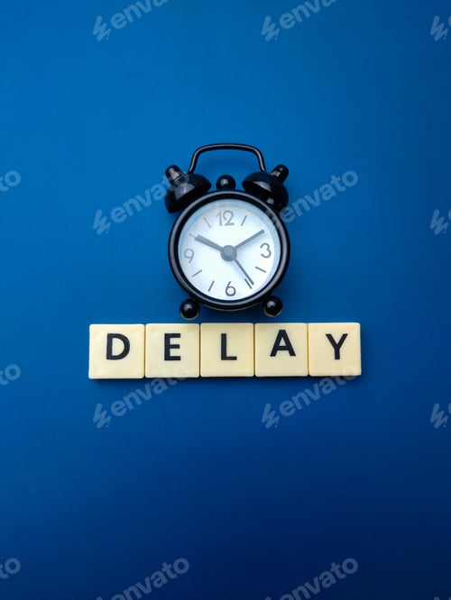 Preview: Black alarm clock with the word DELAY